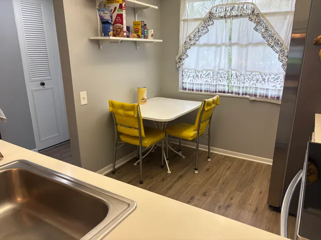 a view of a dining room with furniture and wooden floor
