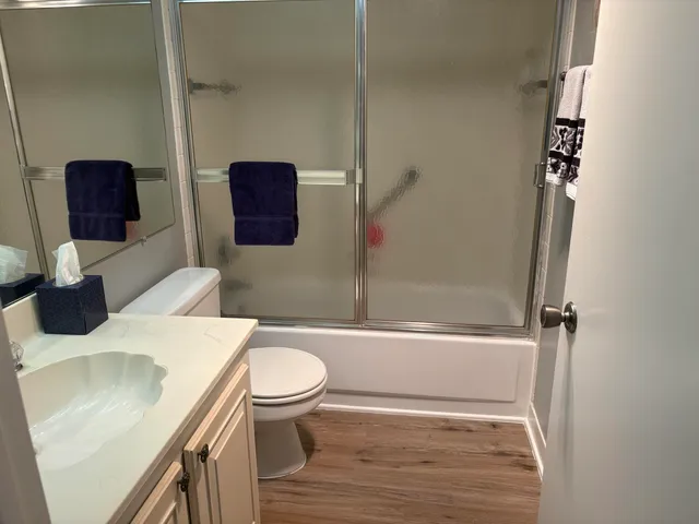 a bathroom with a sink toilet and shower