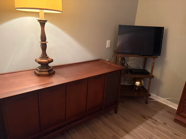 a table chair sitting in a room next to a window