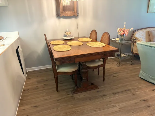 a dining room with furniture and wooden floor