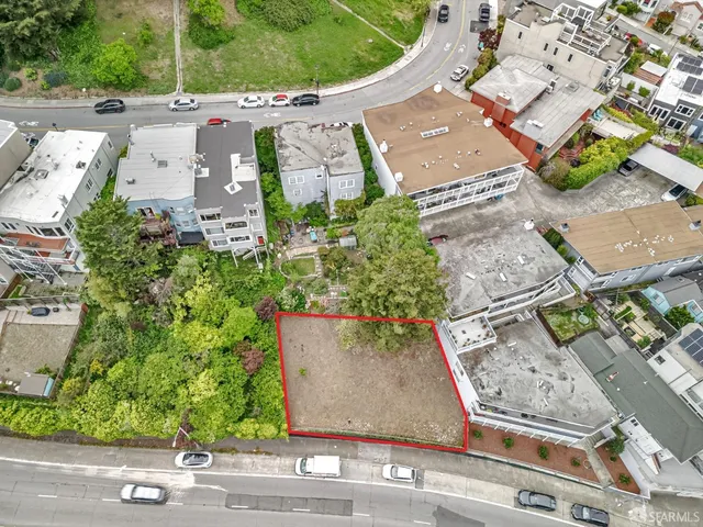 an aerial view of a house with a yard and a garage