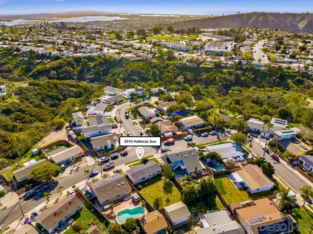 an aerial view of residential houses with city view