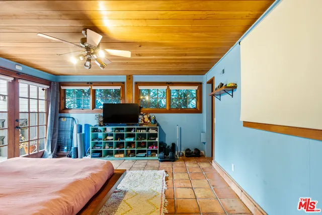 a bedroom with a bed and a chandelier