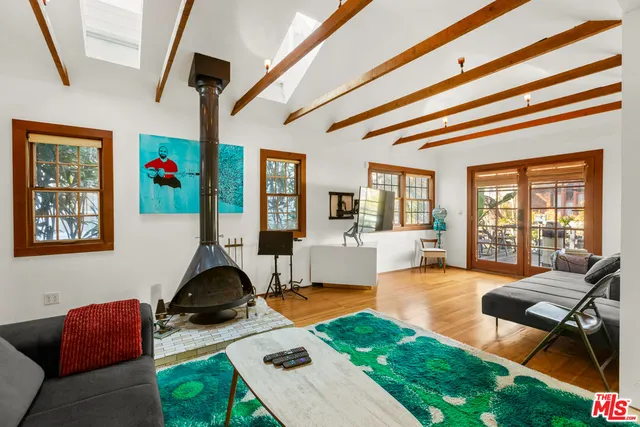 a living room with furniture gym equipment and a large window