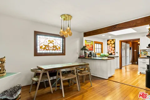 a dining room with furniture and wooden floor