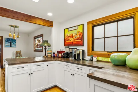 a kitchen with stainless steel appliances wooden cabinets a sink and a window