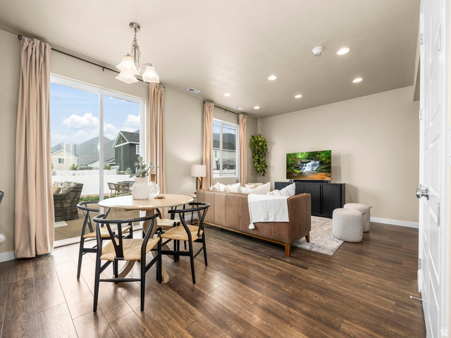 834 West 1050th Street South Springville, UT 84663 - Photo 7 of 26 Open-concept living space with wood-finish flooring, recessed lighting, and a sliding glass door to an outdoor patio