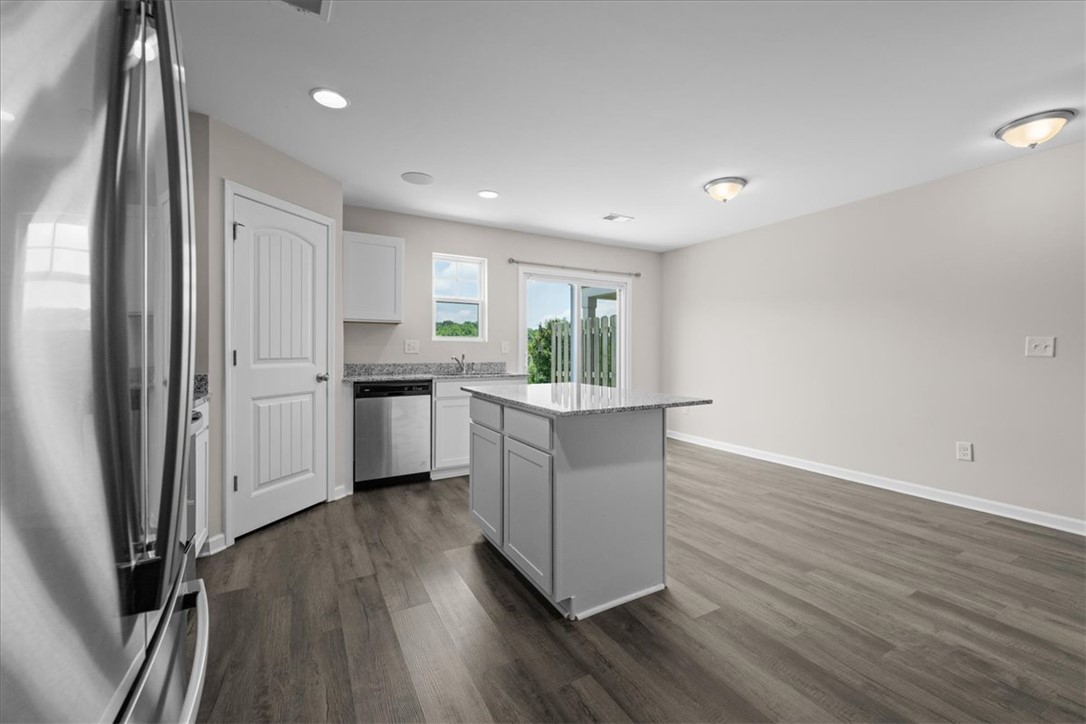 115 Adger Road Pendleton, SC 29670 - Photo 8 of 36 A well-appointed kitchen island with gleaming countertops anchors this bright, open living space.
