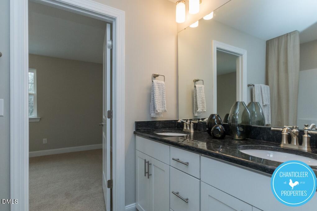 2528 Reynolds Drive Graham, NC 27253 - Photo 16 of 21 a bathroom with double sink and a mirror