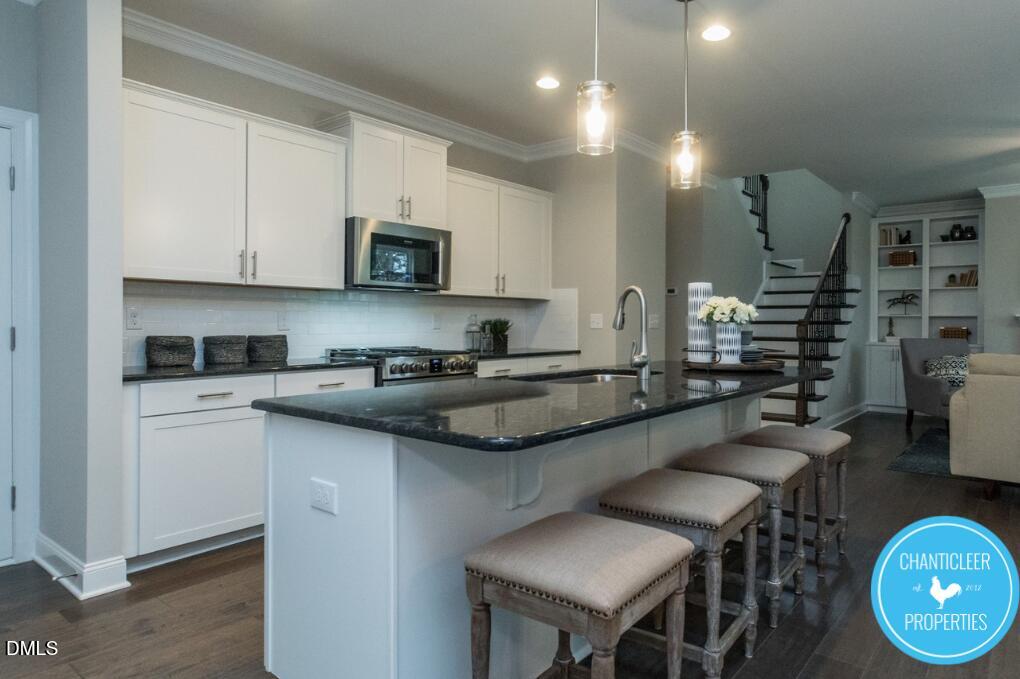2528 Reynolds Drive Graham, NC 27253 - Photo 8 of 21 a kitchen with stainless steel appliances granite countertop a sink and cabinets
