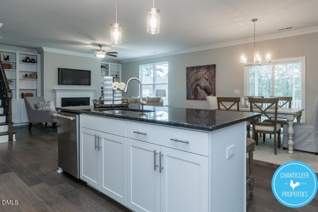 2528 Reynolds Drive Graham, NC 27253 - Photo 9 of 21 a kitchen with granite countertop a stove a sink a dining table and chairs