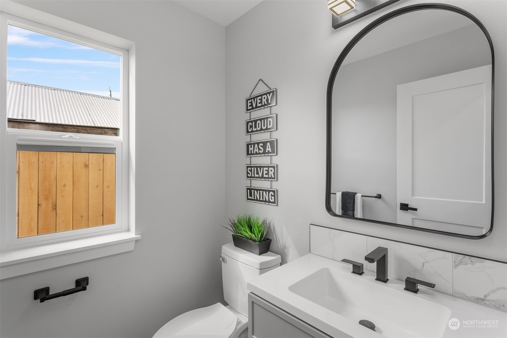 6633 South Pine Street Tacoma, WA 98409 - Photo 14 of 23 a bathroom with a sink a toilet and mirror