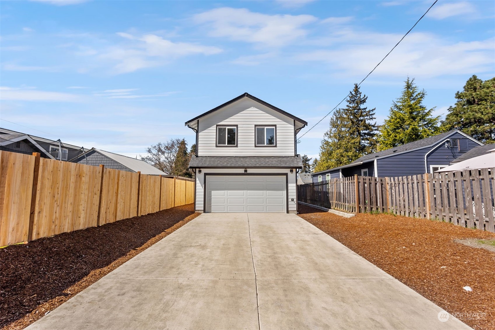 6633 South Pine Street Tacoma, WA 98409 - Photo 23 of 23 a view of a house with wooden fence and floor