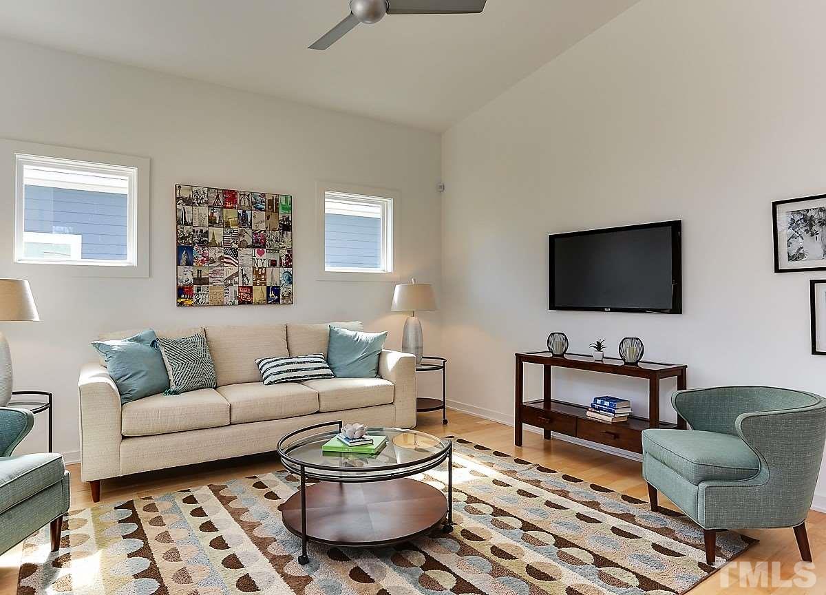 1310 South East Street Raleigh, NC 27601 - Photo 13 of 21 a living room with furniture and a flat screen tv