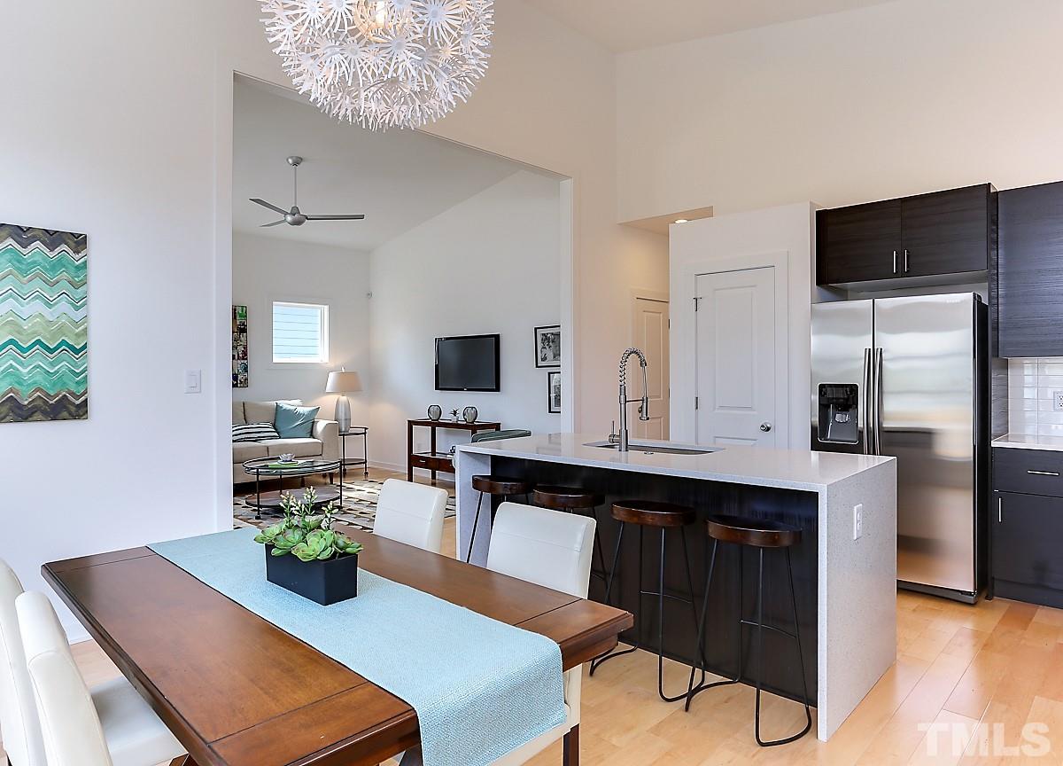 1310 South East Street Raleigh, NC 27601 - Photo 16 of 21 a kitchen with a dining table chairs and refrigerator