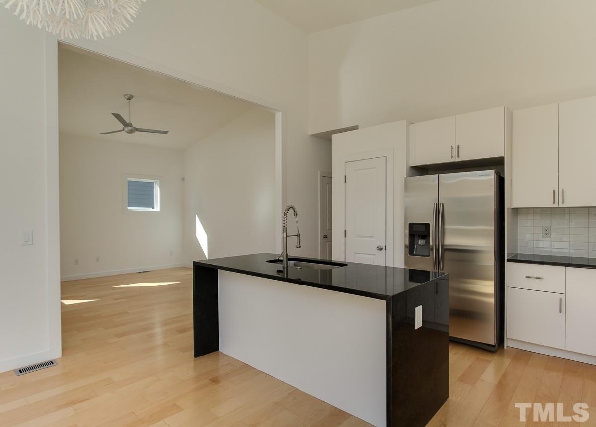 1310 South East Street Raleigh, NC 27601 - Photo 3 of 21 a kitchen with granite countertop a refrigerator and a sink