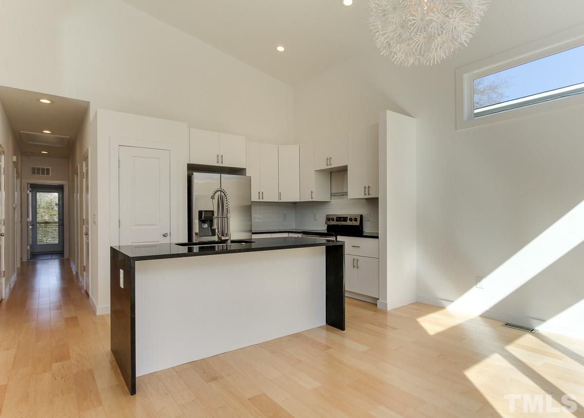 1310 South East Street Raleigh, NC 27601 - Photo 5 of 21 a kitchen with stainless steel appliances a sink stove and cabinets