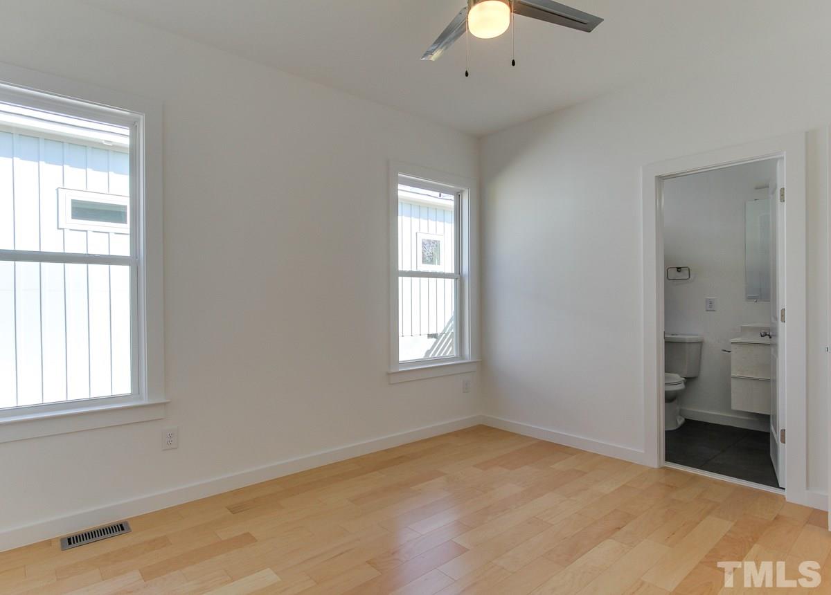 1310 South East Street Raleigh, NC 27601 - Photo 6 of 21 a view of a room with a stylish ceiling fan and window