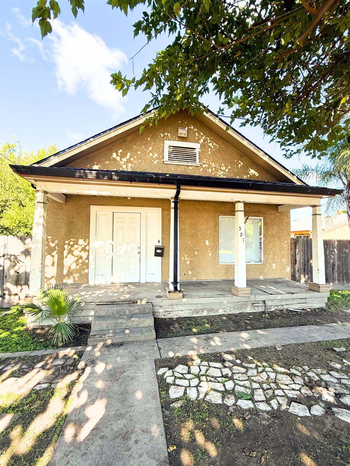 a front view of a house with a yard and outdoor seating