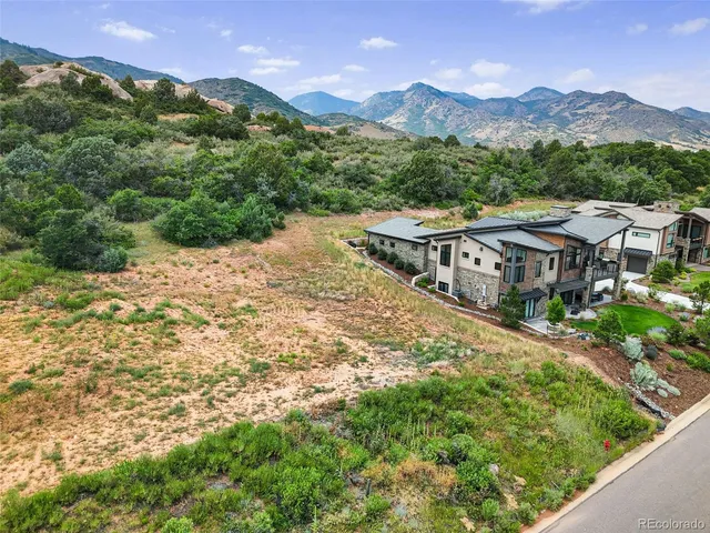 a view of a house with a yard and a wooden fence