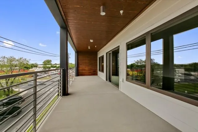 a bathroom with a granite countertop sink a toilet a mirror and shower