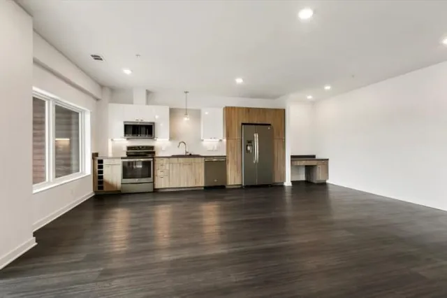 a patio with a table and chairs and potted plants