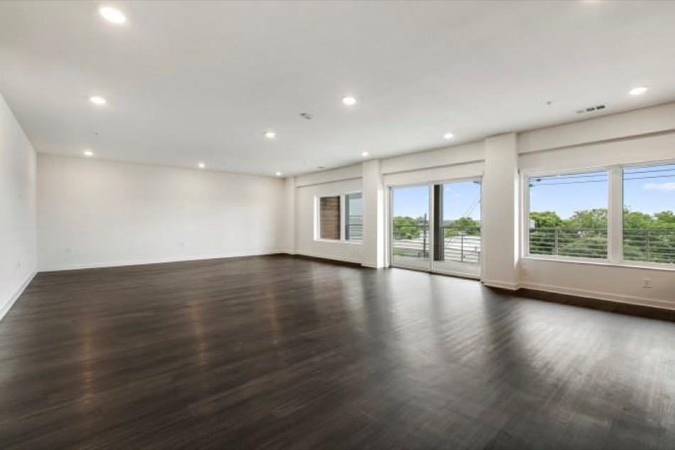 4361 South Congress Avenue, Unit 314 Austin, TX 78745 - Photo 4 of 25 a view of empty room with wooden floor and fan