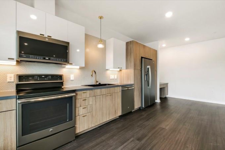 4361 South Congress Avenue, Unit 314 Austin, TX 78745 - Photo 9 of 25 a kitchen with stainless steel appliances a stove microwave and sink