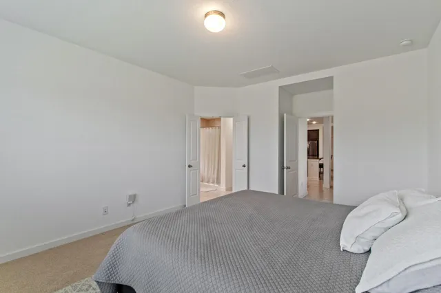 a bedroom with a bed and a lamp