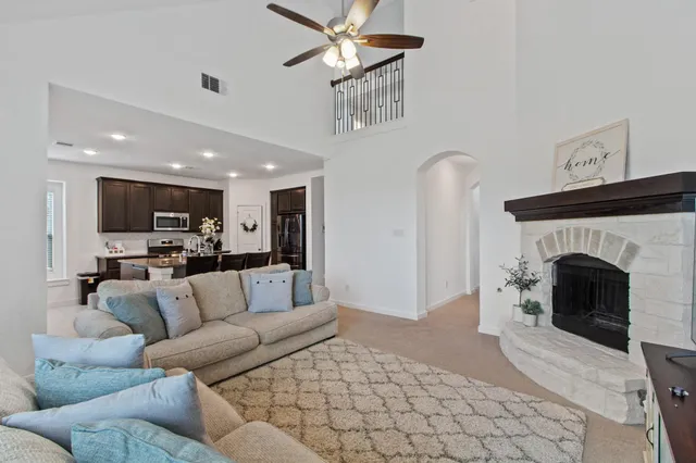 a living room with furniture and a fireplace