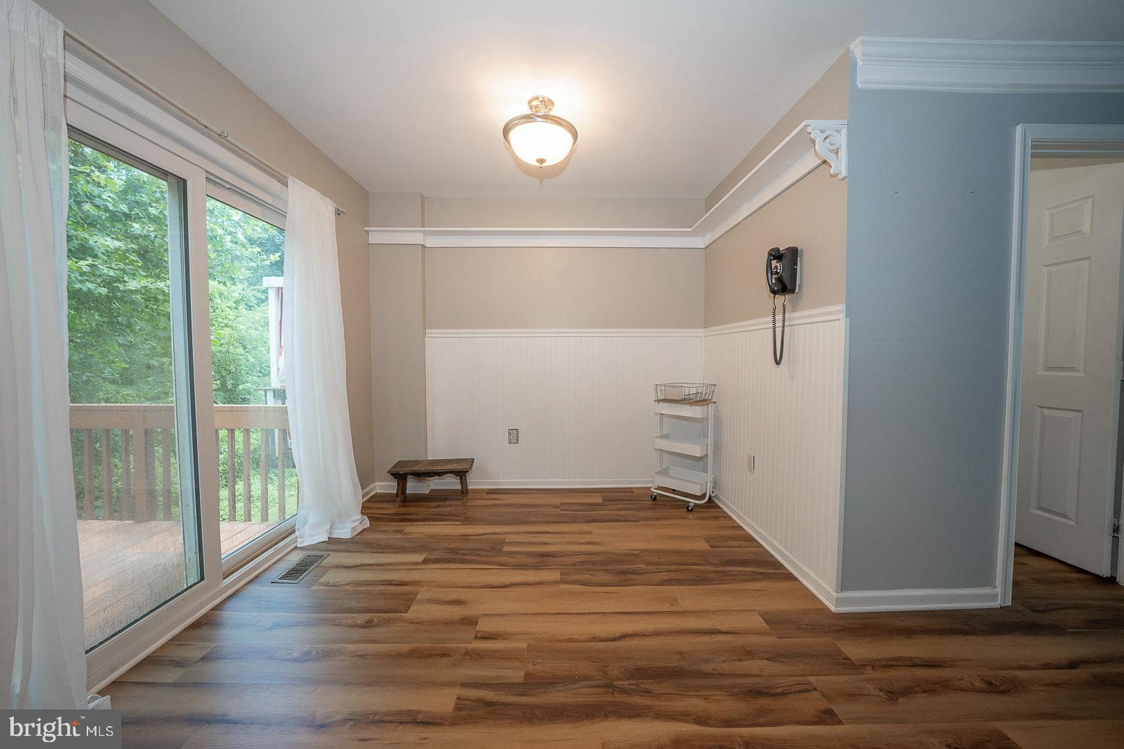 240 Springvalley Way Aston, PA 19014 - Photo 11 of 29 a view of an empty room with wooden floor and a window