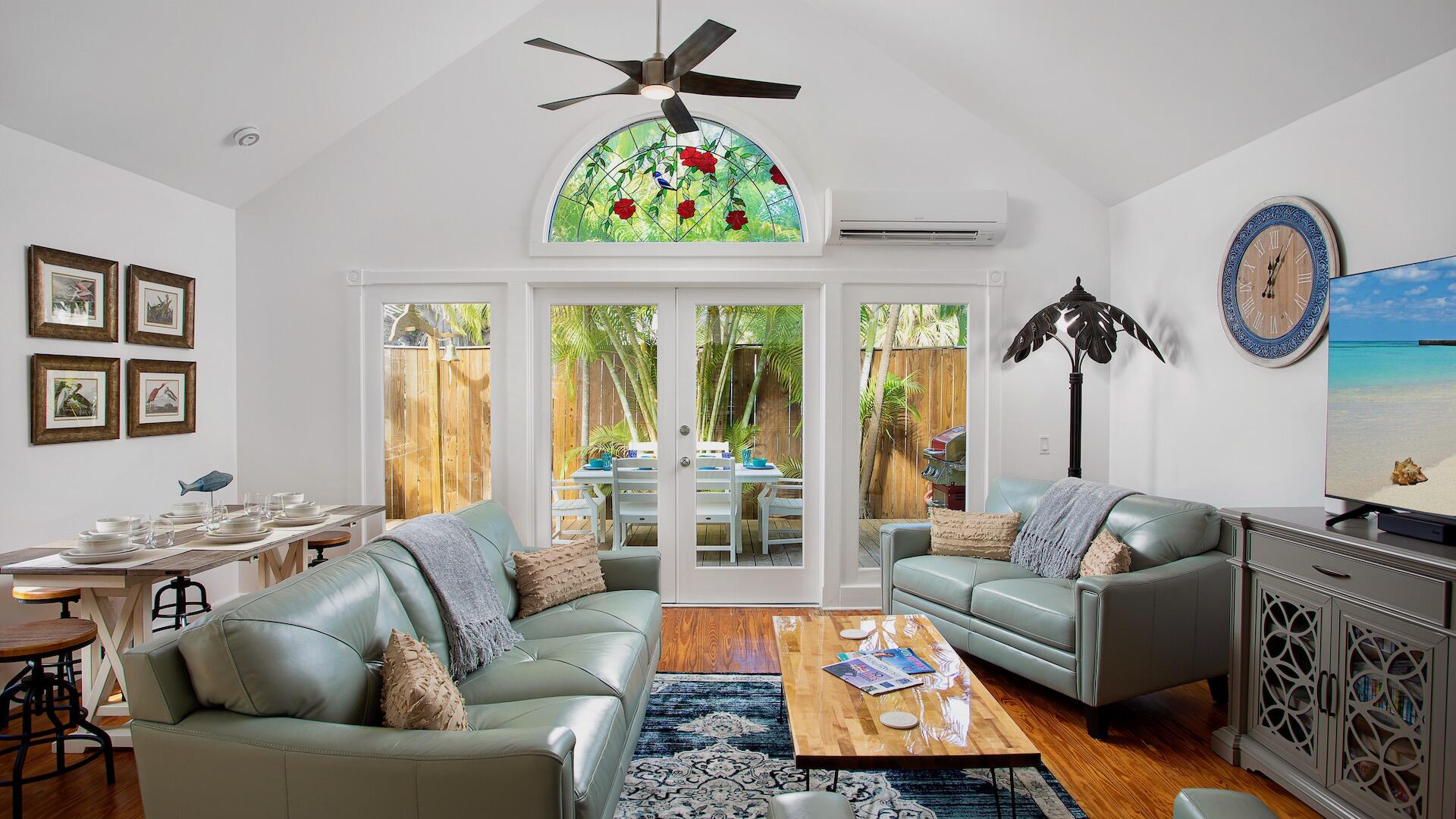 a living room with furniture a rug and a window