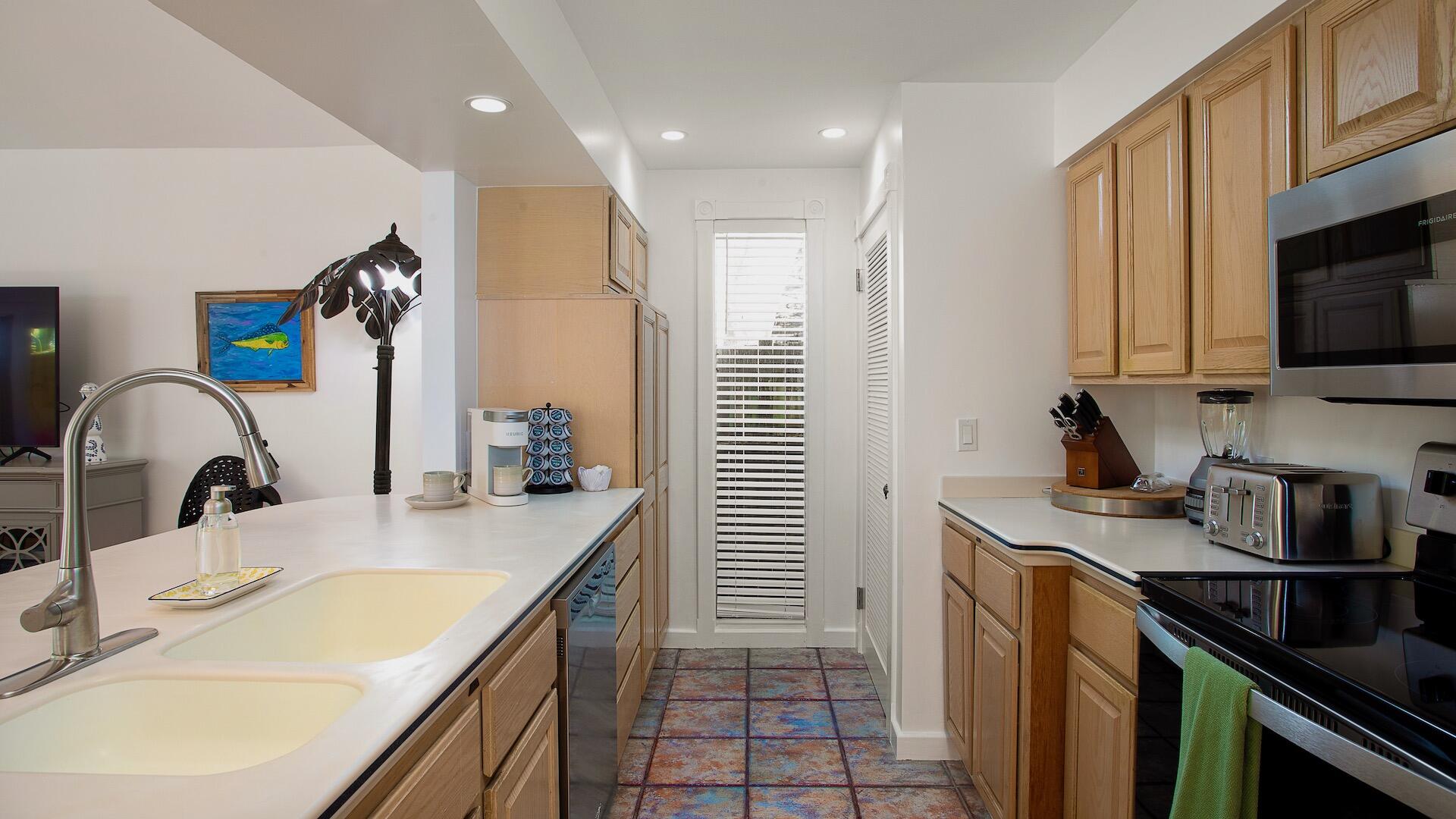 4 Aronovitz Lane Key West, FL 33040 - Photo 12 of 36 a kitchen with a sink and a stove top oven with wooden floor