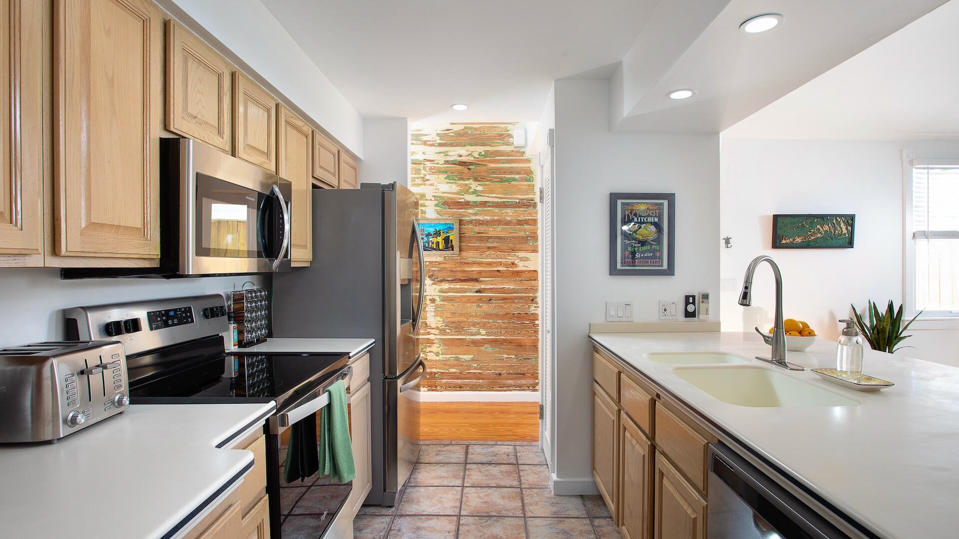 4 Aronovitz Lane Key West, FL 33040 - Photo 13 of 36 a kitchen that has a sink and a stove