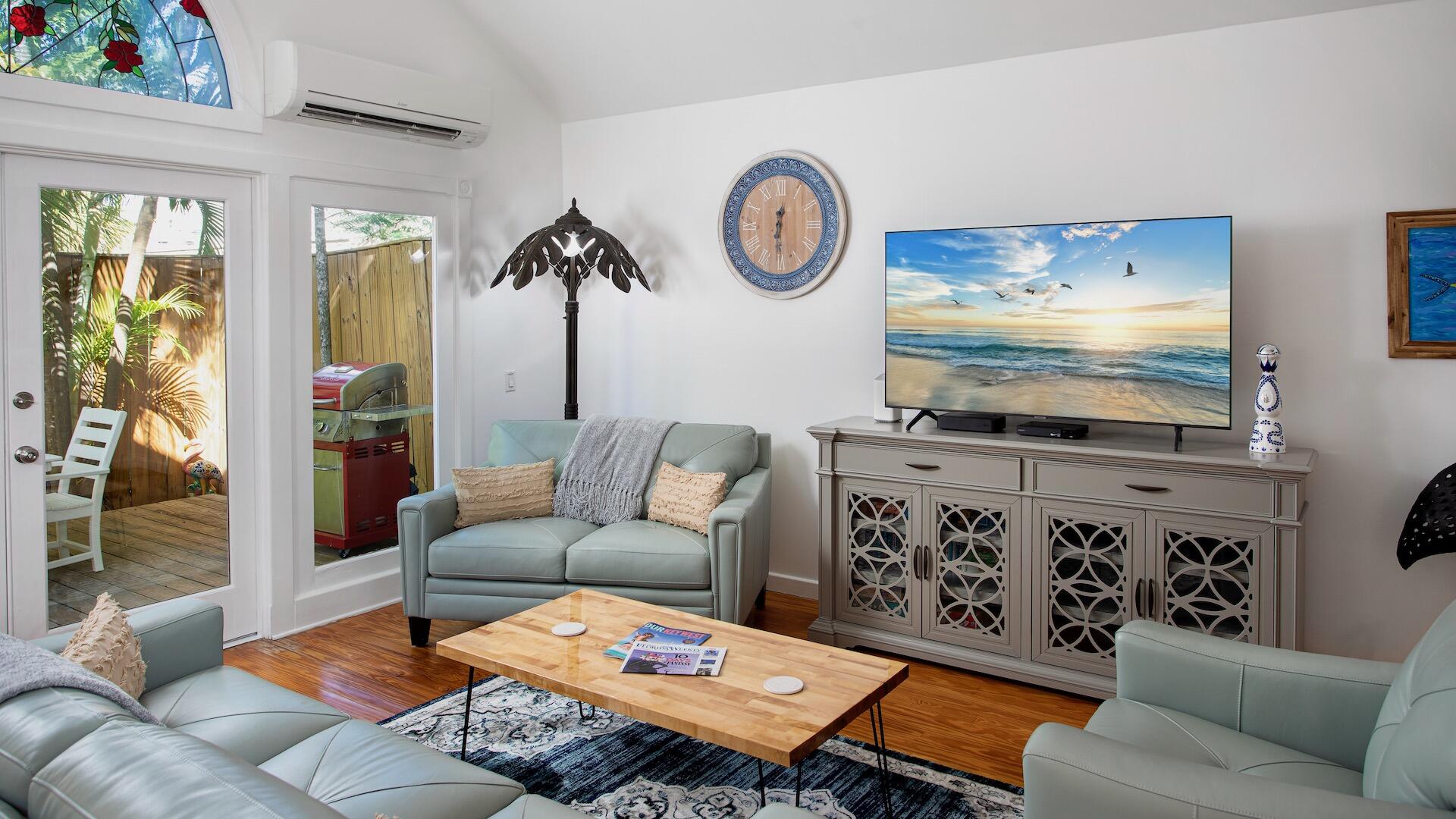 4 Aronovitz Lane Key West, FL 33040 - Photo 2 of 36 a living room with furniture a flat screen tv and a wall painting