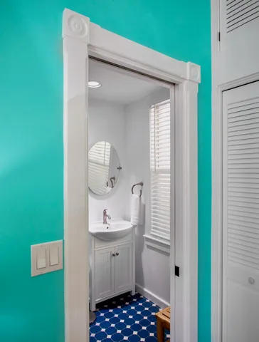 a bathroom with a sink a mirror and window