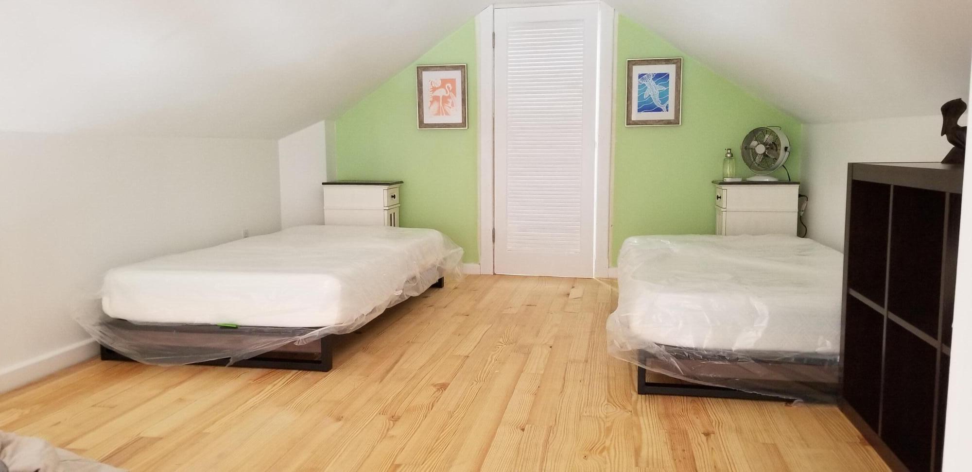 4 Aronovitz Lane Key West, FL 33040 - Photo 31 of 36 a bedroom with a bed and wooden floor