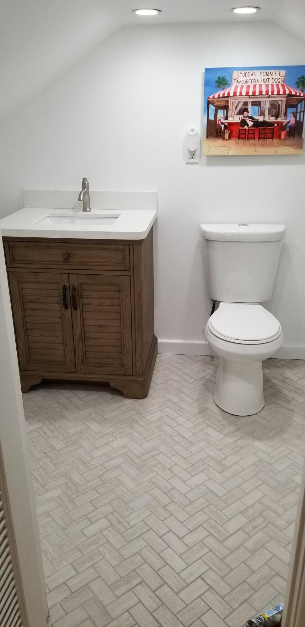 4 Aronovitz Lane Key West, FL 33040 - Photo 32 of 36 a bathroom with a sink a toilet and a mirror