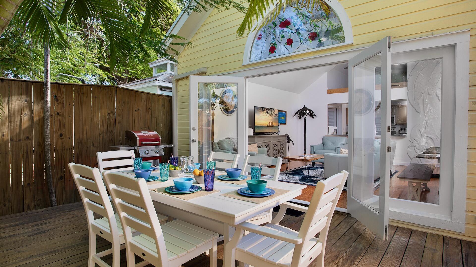 4 Aronovitz Lane Key West, FL 33040 - Photo 8 of 36 a table and chairs in the balcony