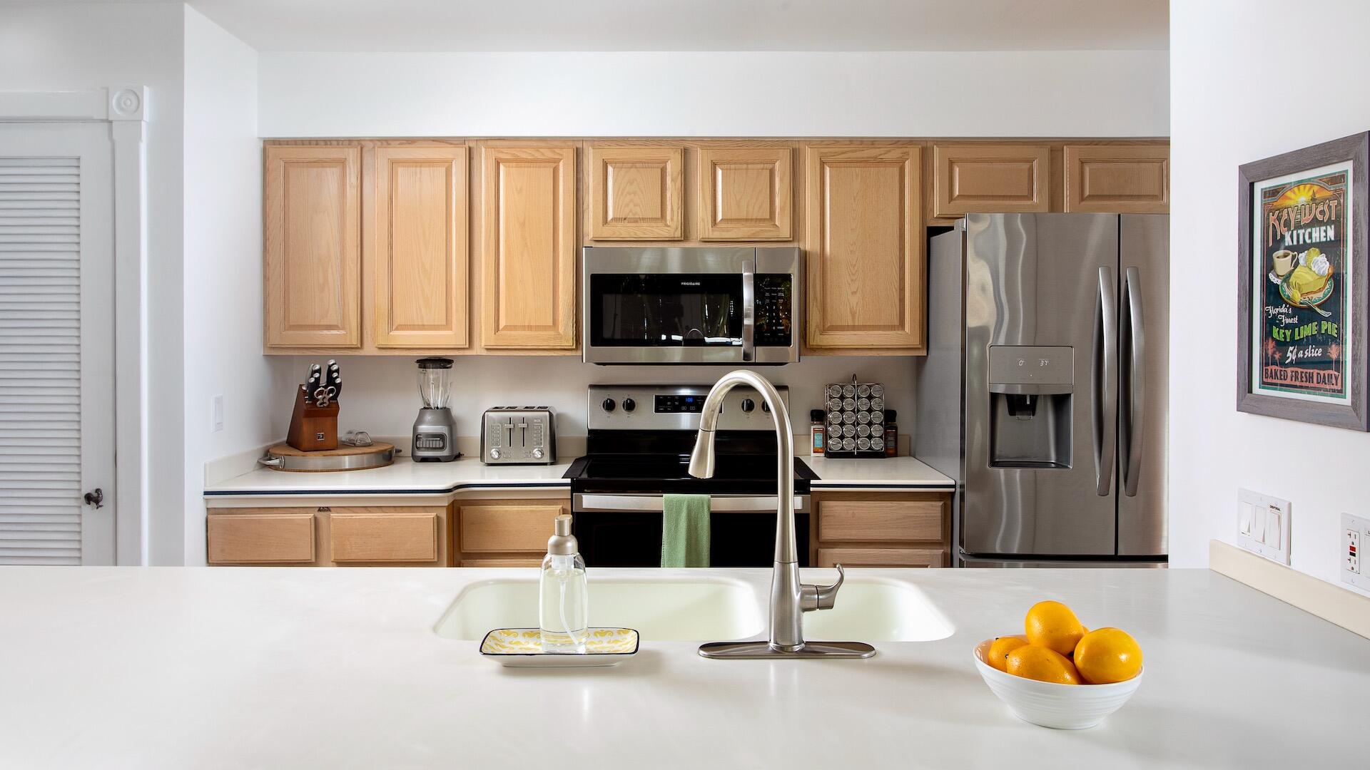 4 Aronovitz Lane Key West, FL 33040 - Photo 9 of 36 a kitchen with stainless steel appliances granite countertop a refrigerator and a stove top oven