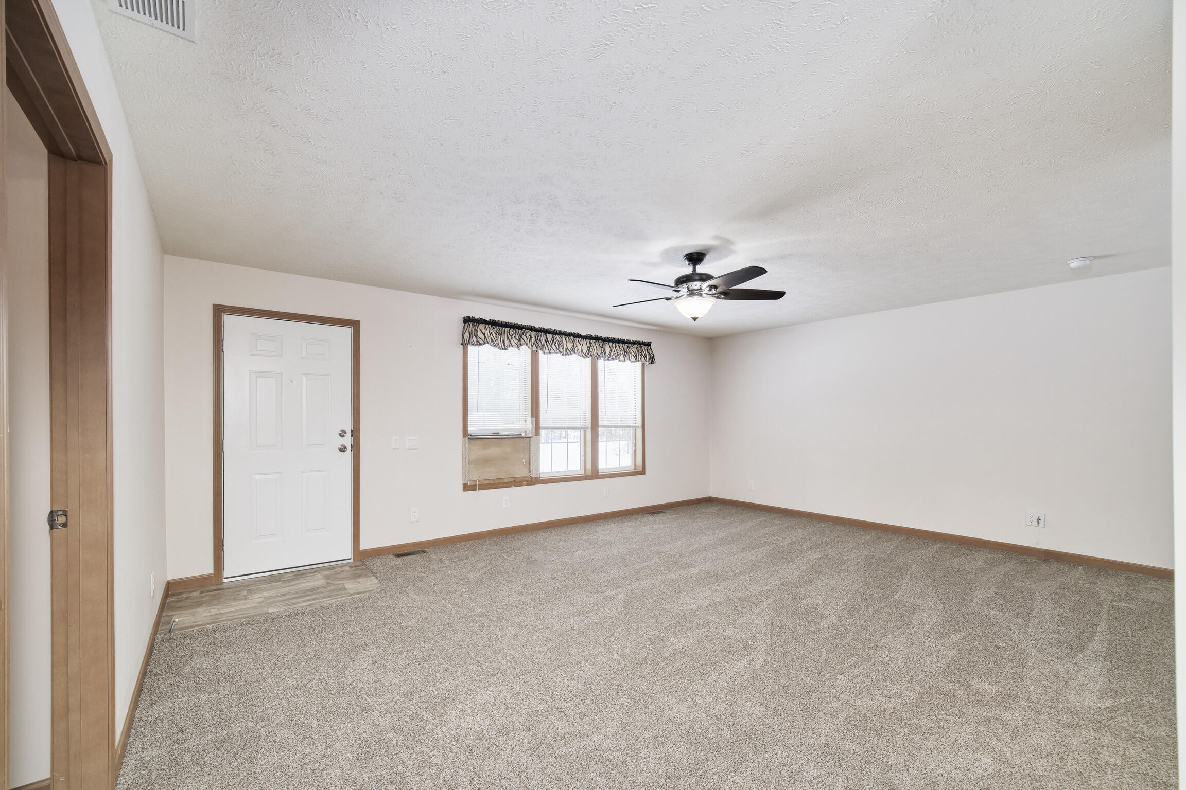 15837 Erwin Road Copemish, MI 49625 - Photo 13 of 54 Front door entrance into living room
