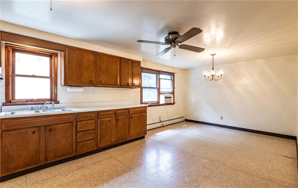 535 Neely Street Baden, PA 15005 - Photo 11 of 42 a kitchen with granite countertop a sink cabinets and window