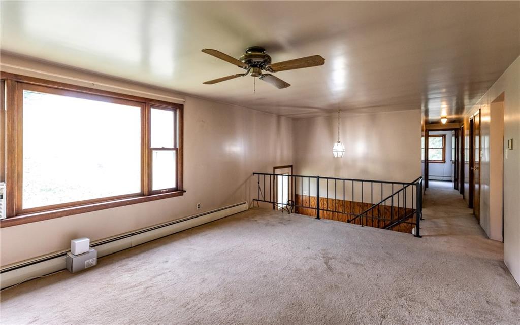 535 Neely Street Baden, PA 15005 - Photo 4 of 42 an empty room with chandelier fan and windows