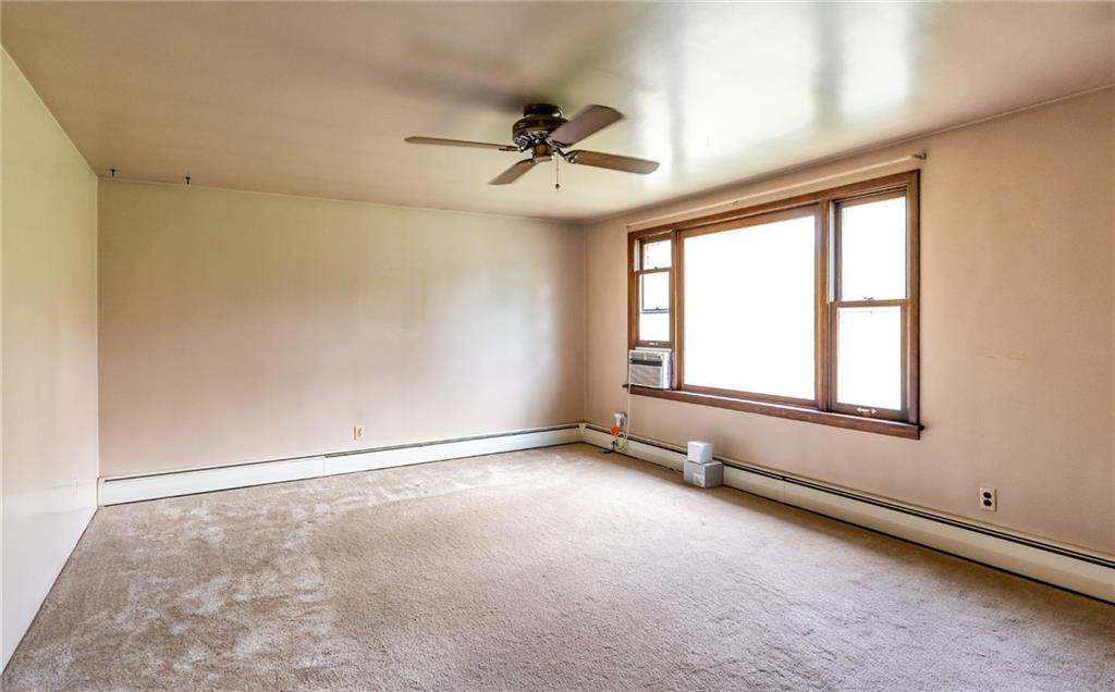 535 Neely Street Baden, PA 15005 - Photo 6 of 42 an empty room with windows and chandelier fan