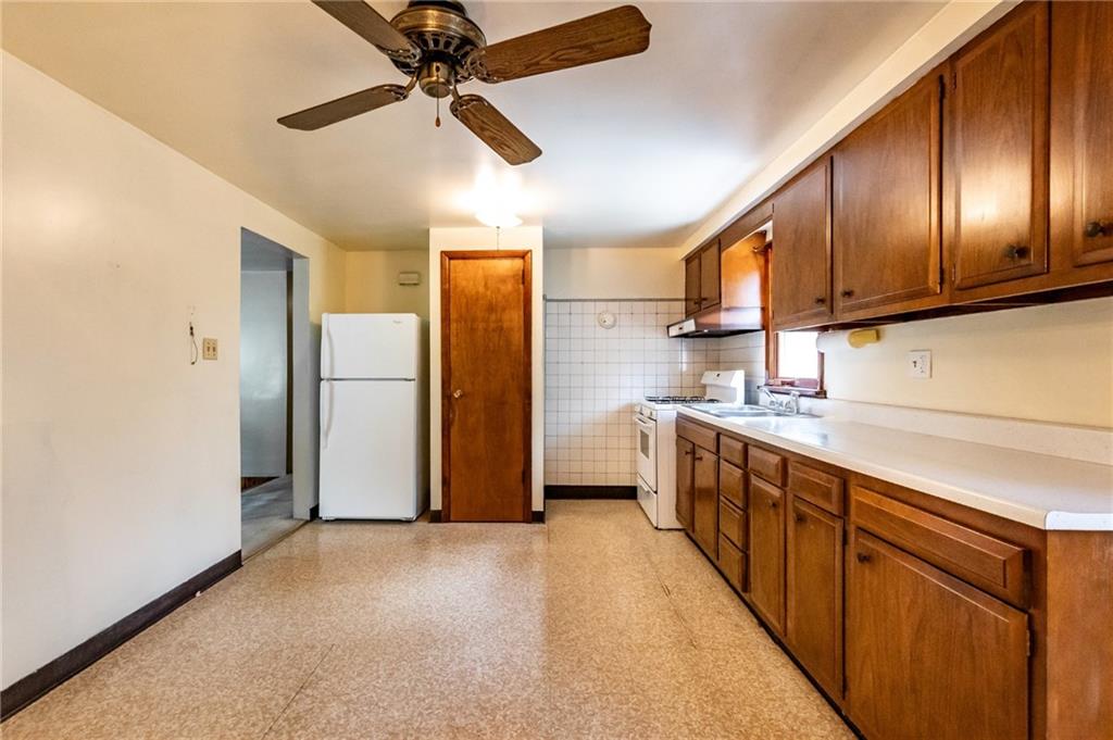 535 Neely Street Baden, PA 15005 - Photo 9 of 42 a kitchen with stainless steel appliances granite countertop a refrigerator a sink and dishwasher