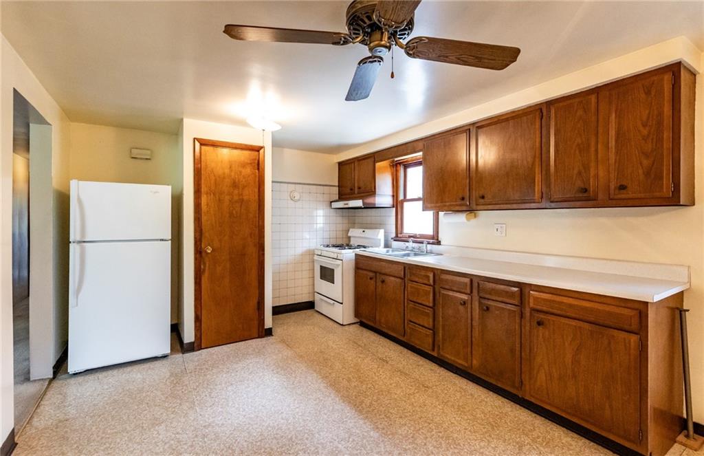 535 Neely Street Baden, PA 15005 - Photo 10 of 42 a kitchen with refrigerator a sink and cabinets