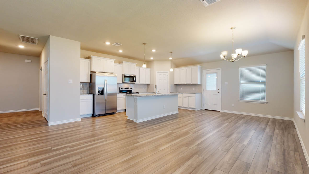 104 Kenzie Street Thorndale, TX 76577 - Photo 7 of 28 a view of kitchen view wooden floor cabinets and stainless steel appliances