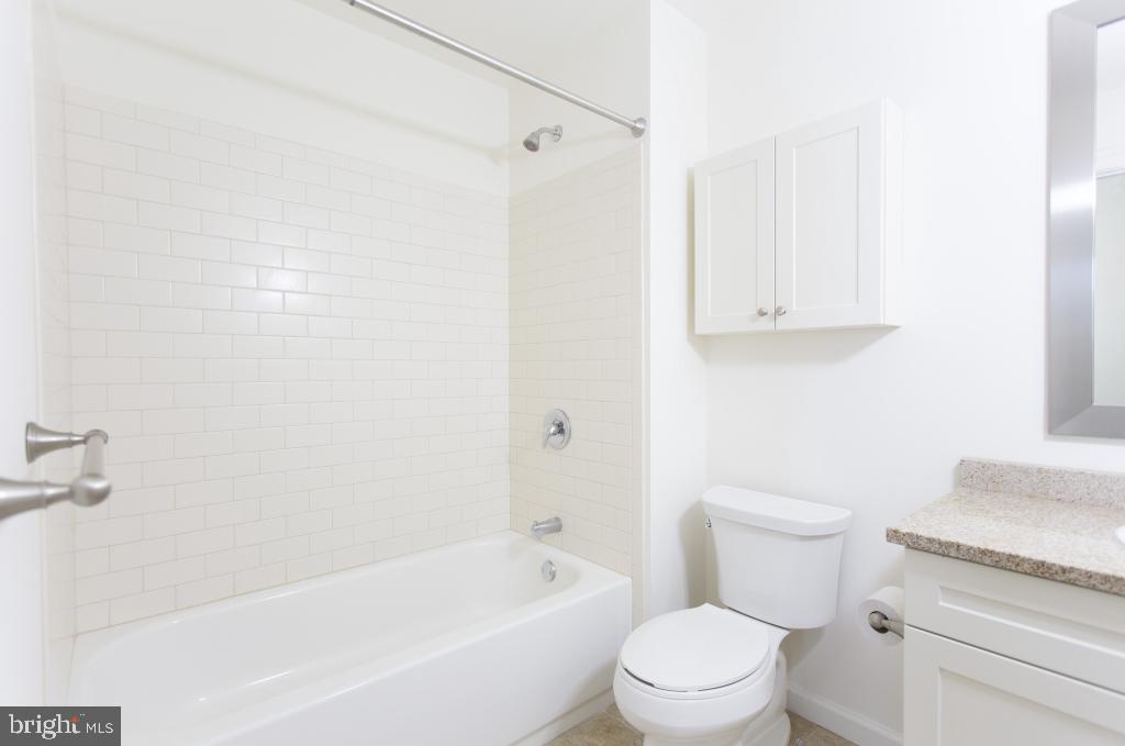 312-22 Walnut Street, Unit G2 Philadelphia, PA 19106 - Photo 10 of 18 a white toilet sitting next to a bath tub