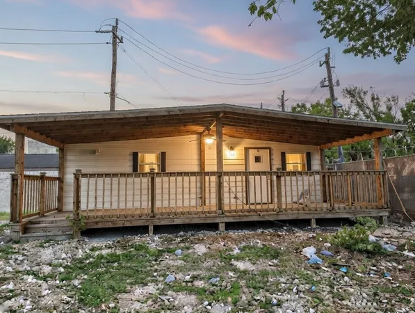 a view of a backyard with wooden fence