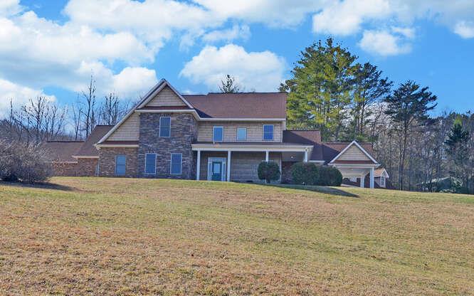 718 Hidden Lake Road Blairsville, GA 30512 - Photo 1 of 34 a view of a house with a yard and large tree